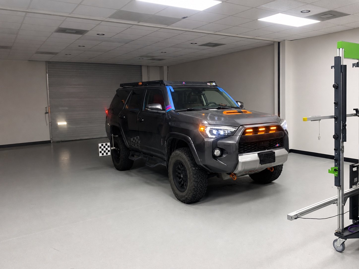 Toyota 4Runner positioned with targets and equipment in a real ADAS calibration room.